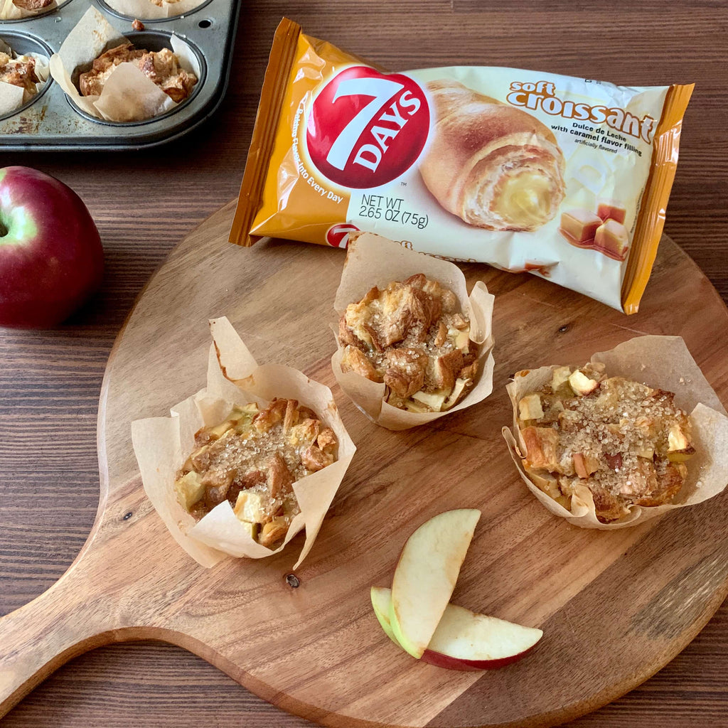 caramel apple cruffins served on a wooden tray with apples